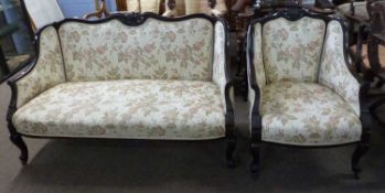A late 19th Century floral upholstered sofa and accompanying armchair, largest piece 138cm wide (2)
