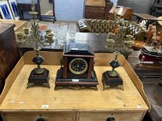 A French black slate and red marble clock garniture, the clock set in an architectural case with