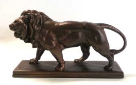 A metal model of a lion on rectangular base impressed Barye, 40cm long