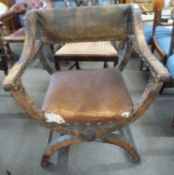 A large 19th Century leather mounted Savonarola type armchair, 72cm wide (a/f)