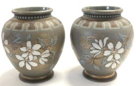 A pair of Lambeth Doulton silicon ware vases, the grey bodies with floral designs by Eliza Simmance,