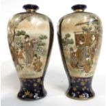 Wooden box containing two Japanese porcelain Satsuma ware vases with panels decorated in gilt in