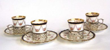 A group of four Aynsley coffee cups and saucers, the cups in silver mounts, assay marks for