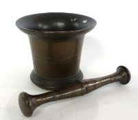 A vintage pestle and mortar, probably bronze or gun metal