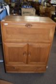 Ercol light elm drinks cabinet with drop down front over a drawer and cupboard base