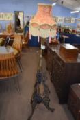 Late 19th Century iron and brass standard lamp with frilled shade, approx 170cm high