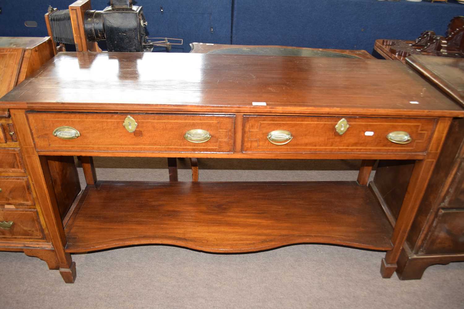 An Edwardian mahogany side table with two frieze drawers and tapering square legs with a
