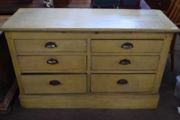A 19th Century painted pine side cabinet with pull out slide over six short drawers, raised on a