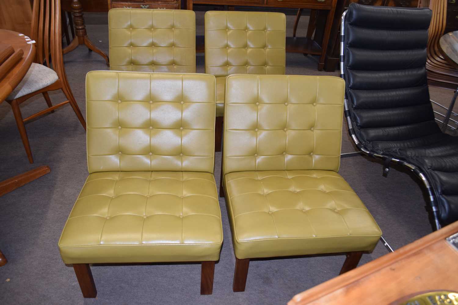 A set of four 1960s hardwood framed and green leatherette upholstered chairs -We have been advised