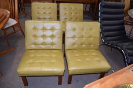 A set of four 1960s hardwood framed and green leatherette upholstered chairs -We have been advised