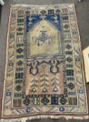 Middle Eastern wool rug with central mihrab on a blue backround 160 x 103cm