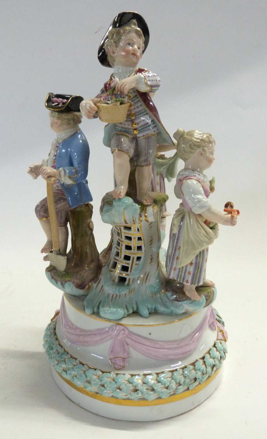 A19th Century Meissen group of children modelled as gardeners and flower sellers on circular base (