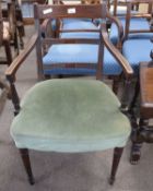 A Georgian mahogany framed armchair with green upholstered seat