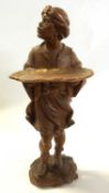 A carved wooden visiting card tray carved as a moorish gentleman, 42cm high