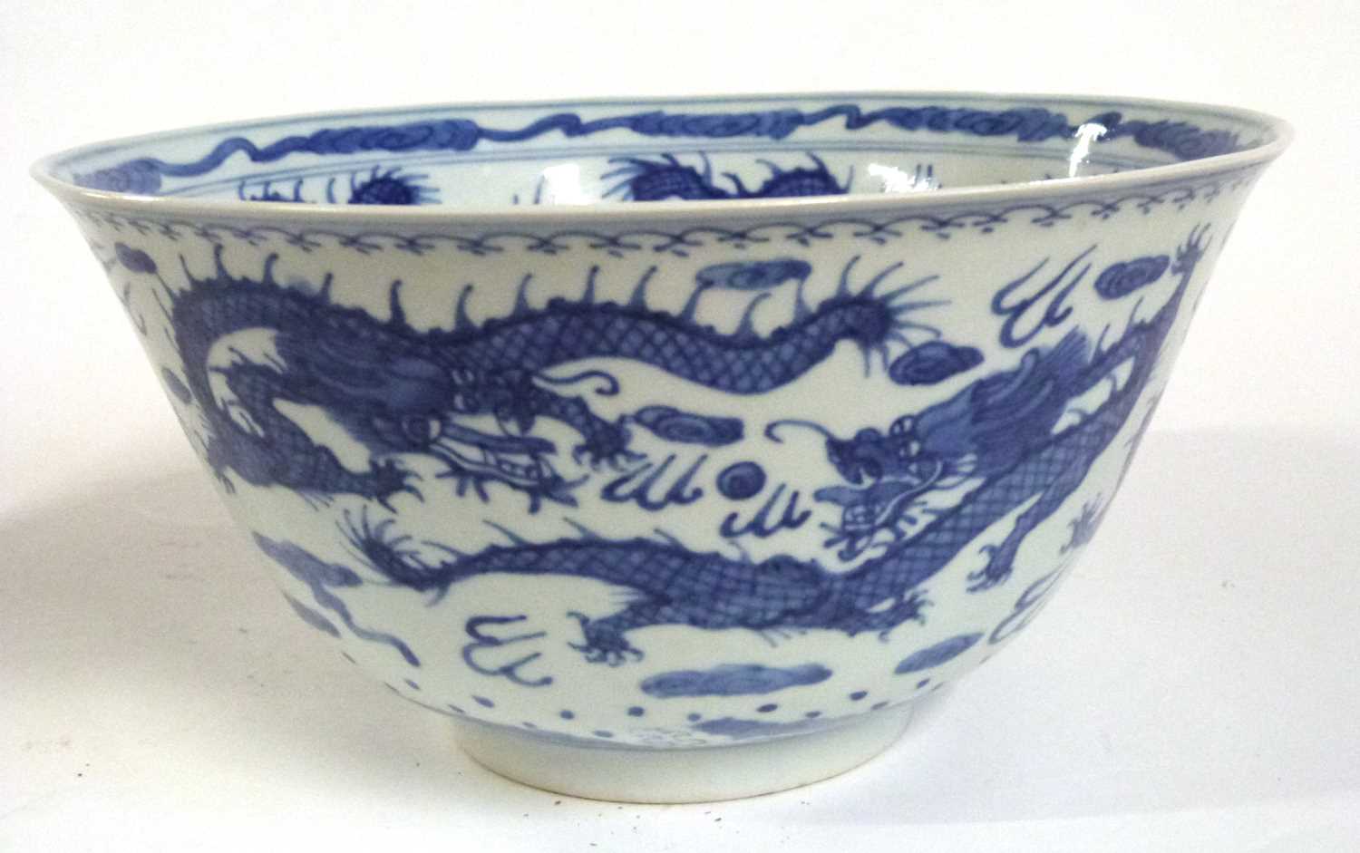 A Chinese porcelain bowl with everted rim, blue and white decorations of dragons chasing the flaming - Image 3 of 6