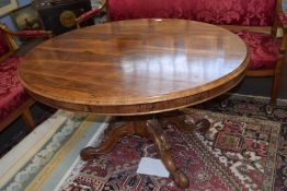 A Victorain oval rosewood centre or loo table with tilt top on pedestal base. Top 132 cm wide