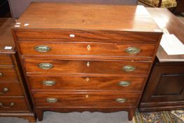 A small Georgian mahogany chest with four graduated drawers and oval brass handles, 85cm wide