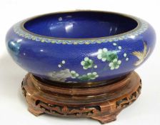 A large Cloisonne bowl, the blue ground finely decorated with flowers and birds, the bowl raised