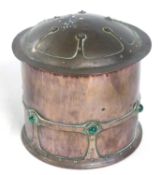 An Arts & Crafts copper jar and cover with applied cabochon type decoration indistinct (CRB?)