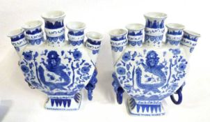 A pair of Chinese porcelain tulip vases decorated in blue and white with dragons chasing the flaming