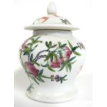 A Chinese porcelain small jar and cover with polychrome decoration of peaches and bats, 14cm high