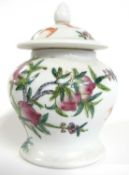 A Chinese porcelain small jar and cover with polychrome decoration of peaches and bats, 14cm high