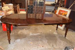 A Victorian mahogany oval extending dining table raised on turned legs together with two extension
