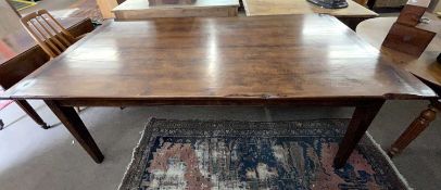 A large reproduction oak rectangular dining table with cleated four plank top raised on tapering