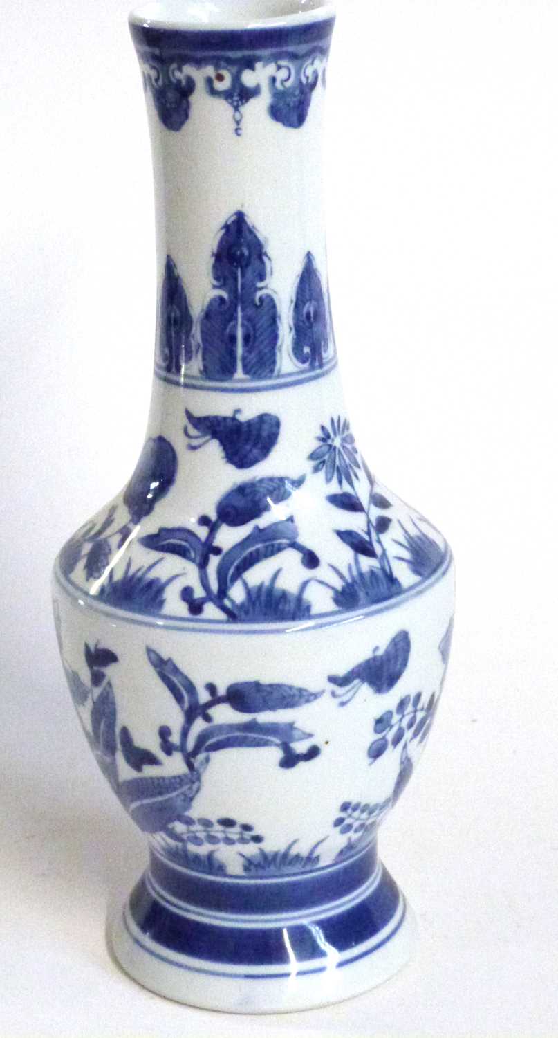 A Chinese porcelain vase, 20th Century with a painted blue and white floral design, 32cm high - Image 2 of 9