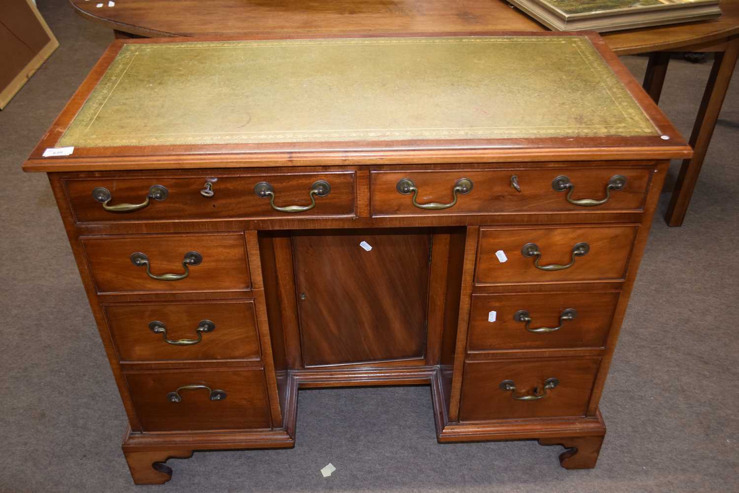 Arthur Brett of Norwich - A reproduction mahogany veneered knee hole desk with green leather writing