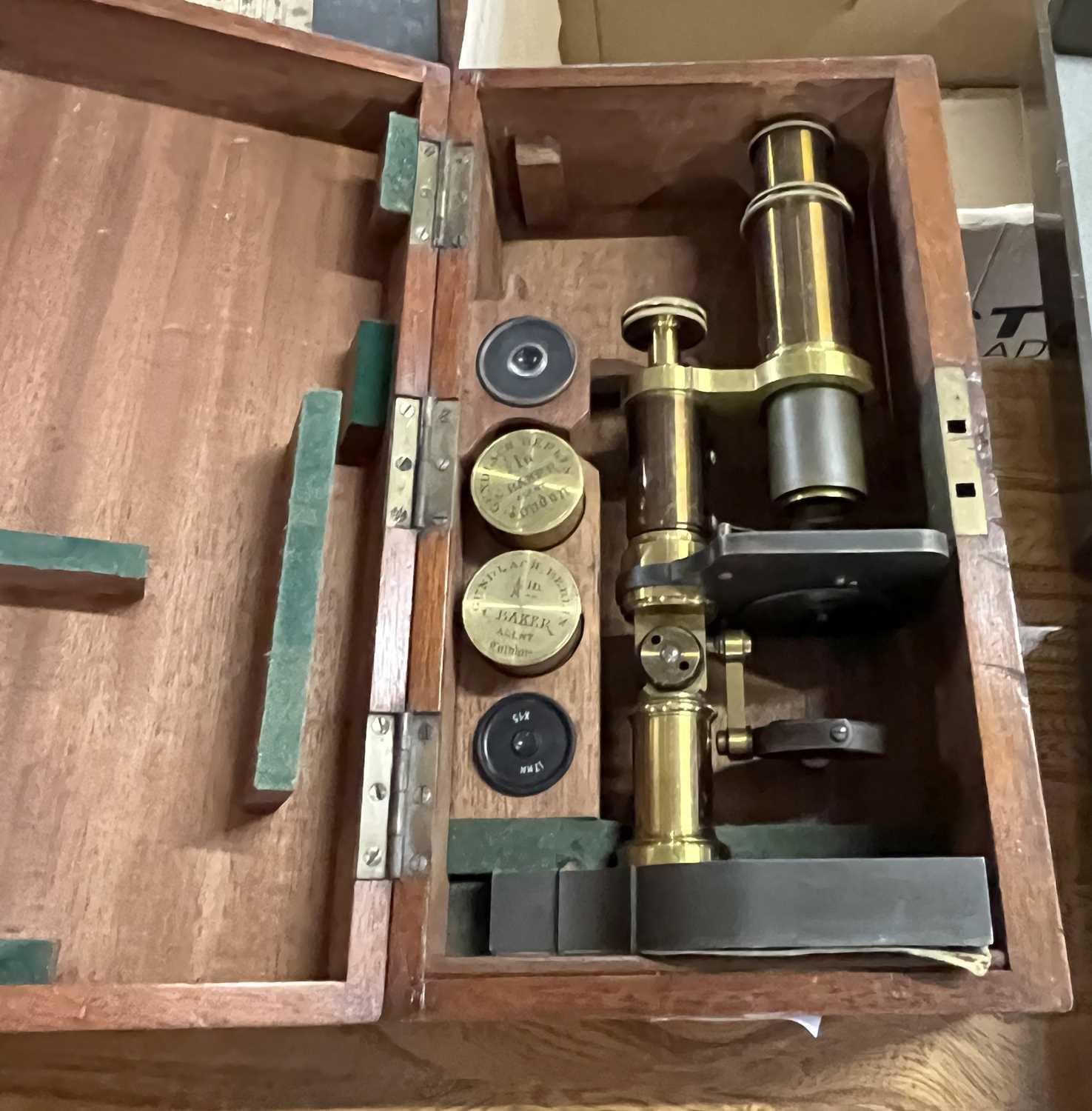 Baker - A brass and Steel cased monocular microscope set in hardwood case