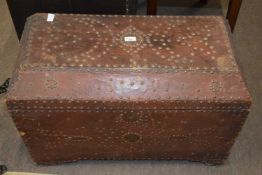 An unusual 19th Century leather mounted and brass studded trunk of sarcophagus form, 80cm wide