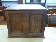 An early 20th Century hardwood collectors cabinet fitted with panelled door opening to sixteen