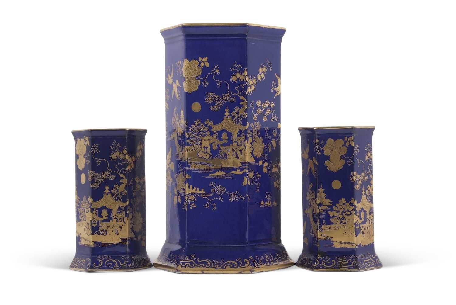 A garniture of Cauldon early 20th Century vases of faceted shape with gilt chinoiserie design