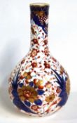 A 19th Century Derby porcelain bottle vase decorated with a typical Imari design, 23cm high