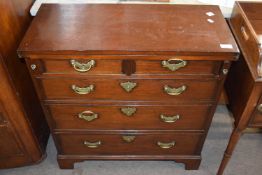 A small Georgian and later bachelors chest with folding top over a base with two short and three