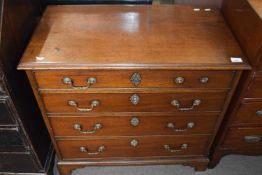 A small Georgian mahogany chest with four graduated drawers fitted with swan neck handles and