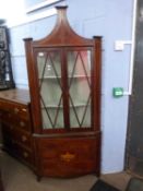A 19th Century mahogany and inlaid corner display cabinet with two glazed doors over a cupboard