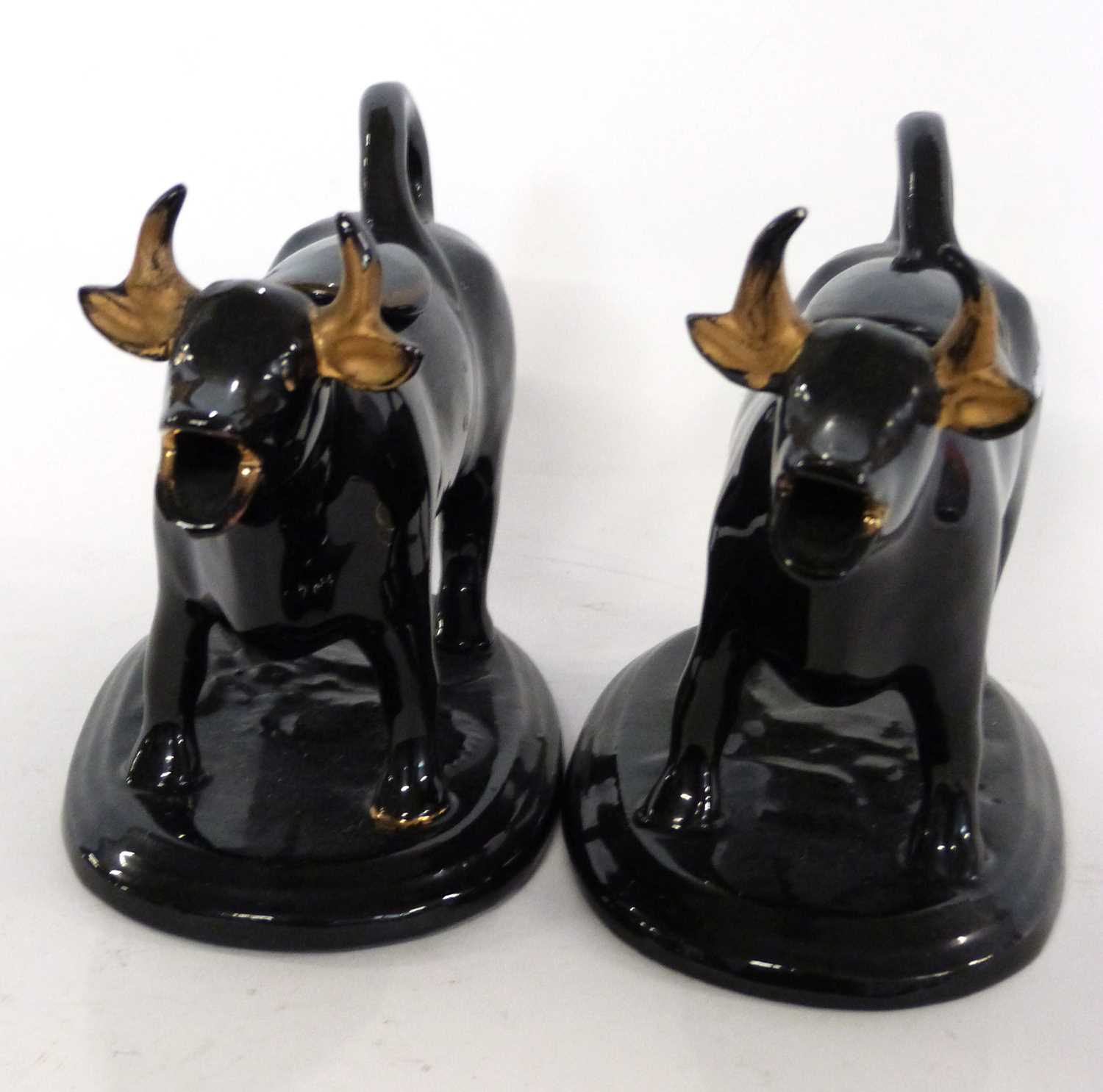 A pair of Jack Field type black and gilt cow creamers - Image 2 of 3