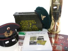 Box containing a quantity of militaria including a East German beret and Royal Artillery shell case,