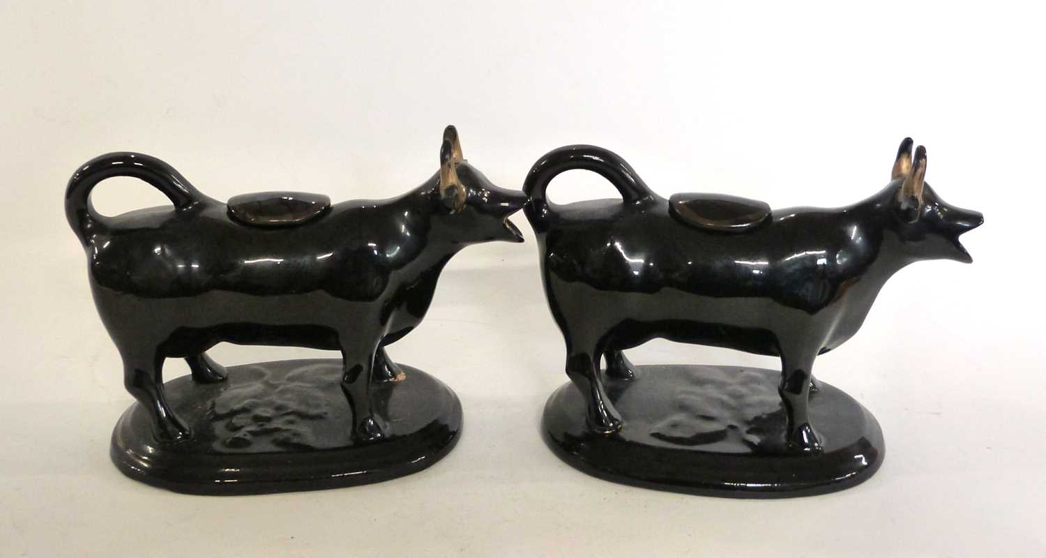 A pair of Jack Field type black and gilt cow creamers - Image 3 of 3