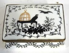 A Crown Staffordshire patch box with painted design of crows by a bird cage with the slogan "It is