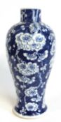 A 19th Century Chinese vase of baluster form, the blue ground with prunus decoration, four character