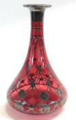 A continental ruby coloured glass decanter with Art Nouveau metal overlay in WMF style with metal