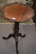 A reproduction Georgian style wine table with tapering column and tripod base with claw feet