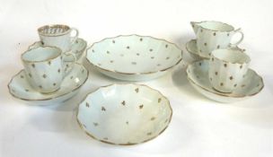 A late 18th Century Lowestoft porcelain part tea set comprising two coffee cups with unusual shape