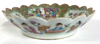 A 19th Century Cantonese porcelain bowl with fluted rim decorated in typical fashion with panels