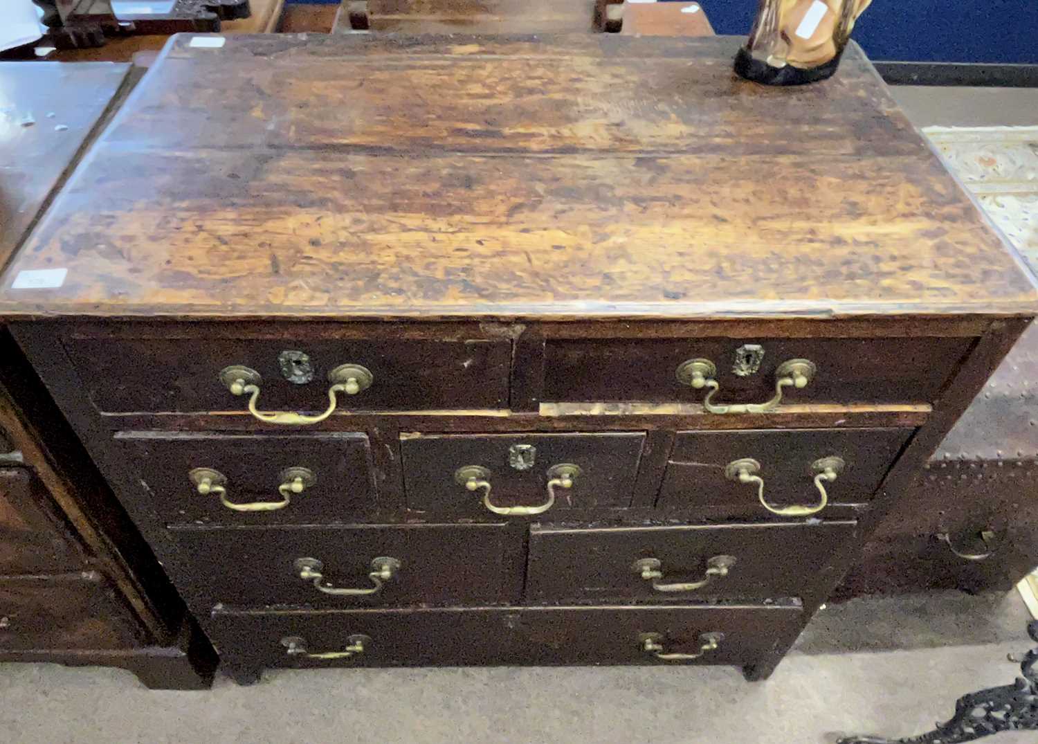 A Georgian oak chest of drawers with an unusual configuration of seven short and one long drawer, - Image 2 of 3