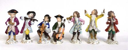 A group of seven monkey band figures, continental porcelain in Meissen style, largest figure 13cm