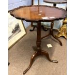 Georgian style mahogany wine table with shaped top over a turned column and tripod base, 70cm high